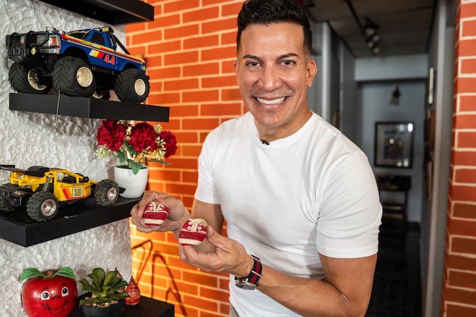 En la foto, Alex DJ enseña unas zapatillas que usó de bebé. Su madre las guarda de recuerdo en su hogar.