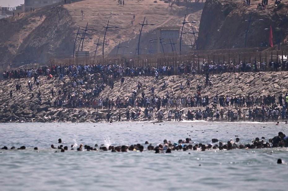 Migrants cross from Morocco into the Spanish enclave of Ceuta, Thursday, July 30, 2026. (AP Photo/Antonio Sempere)