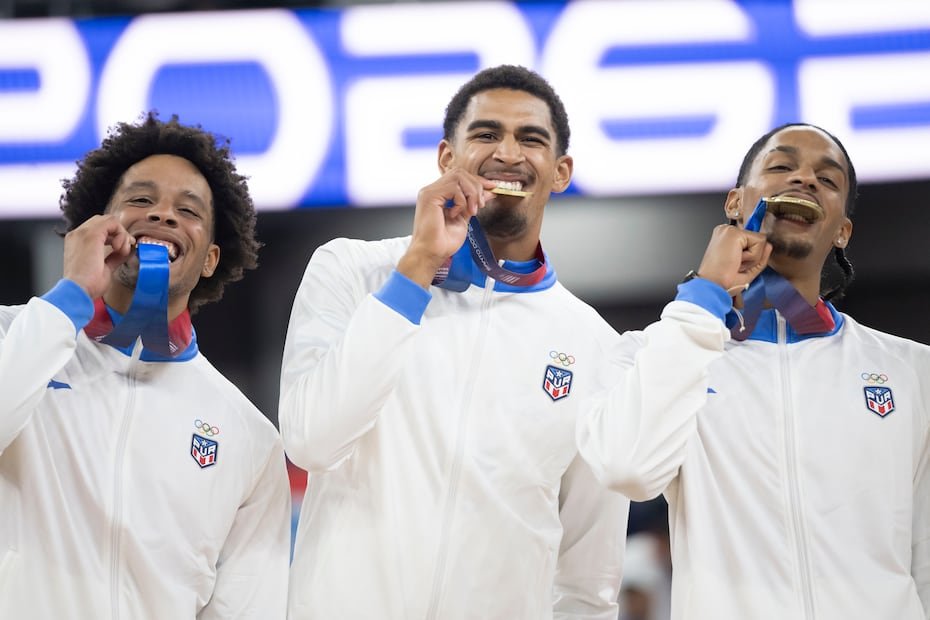 Los jugadores de Puerto Rico hacen la tradicional celebración de morder la medalla.