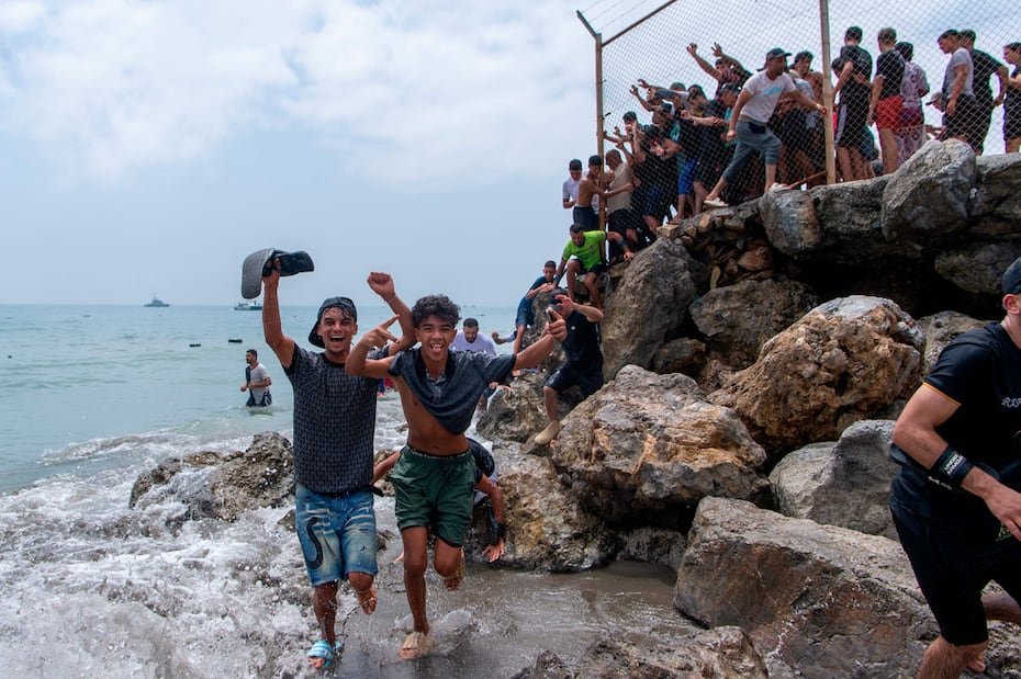 Migrants cross from Morocco into the Spanish enclave of Ceuta, Thursday, July 30, 2026. (AP Photo/Antonio Sempere)